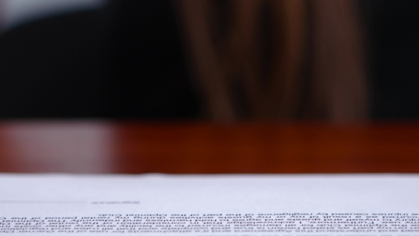 Worker Is Doing Office Work On Documents With a Rectangular Print. 