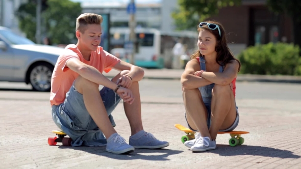 Teenage Couple With Penny Boards Talking In City 29