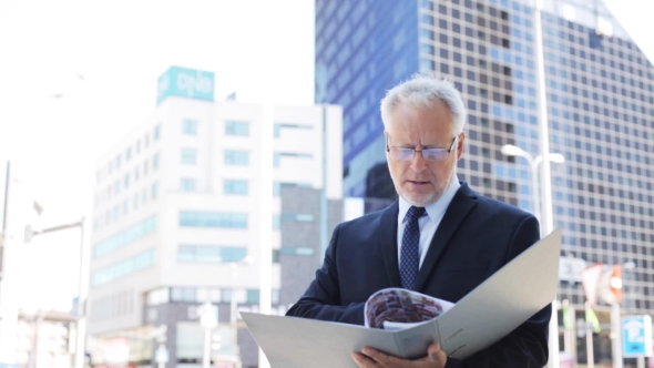 Senior Businessman With Ring Binder Folder In City