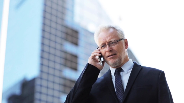 Senior Businessman Calling On Smartphone In City