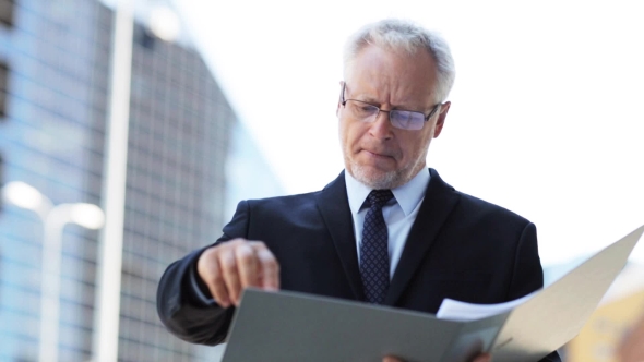 Senior Businessman With Ring Binder Folder In City