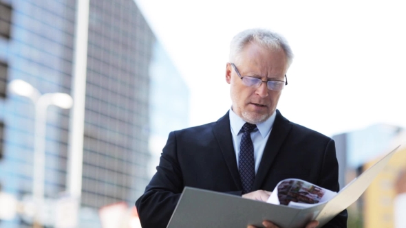 Senior Businessman With Ring Binder Folder In City