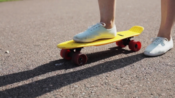 Teenage Girl Right Foot On Short Modern Skateboard