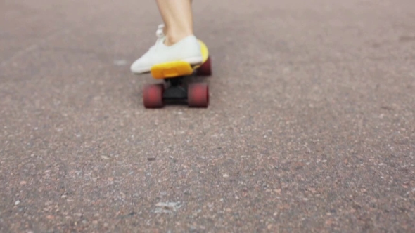 Teenage Girl Feet Riding Short Modern Skateboard