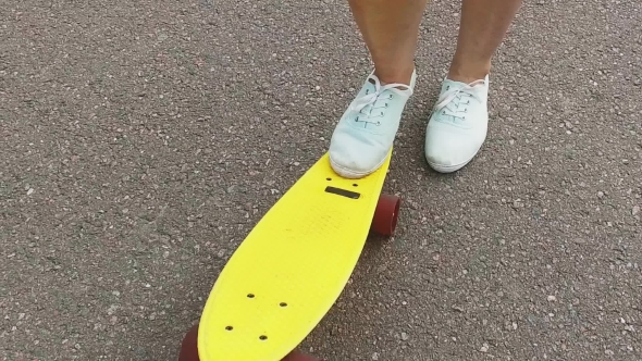Teenage Girl Foot Putting Short Skateboard On End