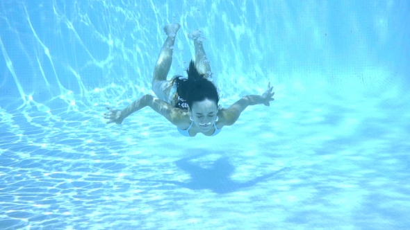 Girl Swimming Underwater In a Swimming Pool