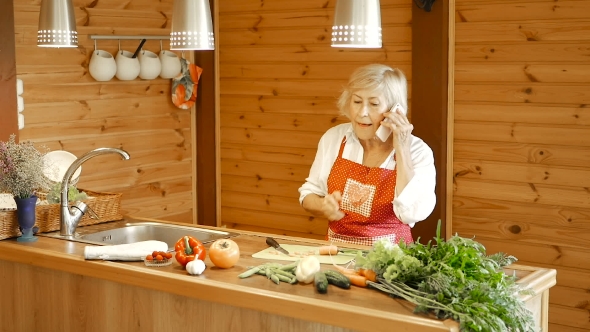 Elderly Woman Slices Carrots and Answers the Call