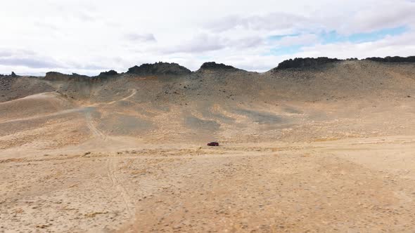 Vehicle Drives Within National Reserved Area with Barren Landscape