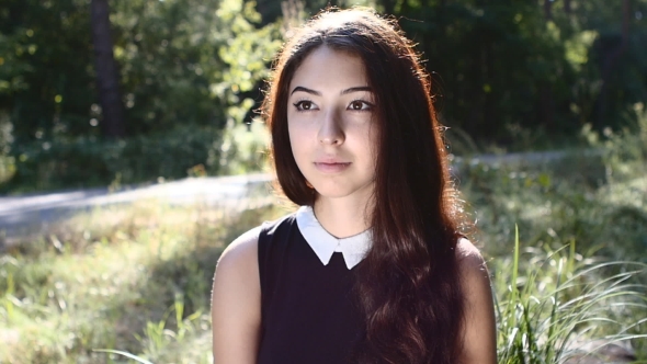  Portrait Of Young Attractive Brunette Looking At Camera Outdoor