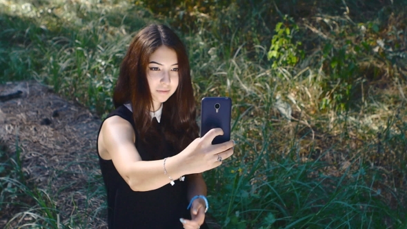 Girl Doing Selfie On Her Smartphone Outdoor