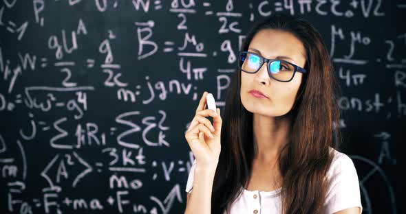 Beautiful Brunette Woman Posing Over School Board With Math Formulas.