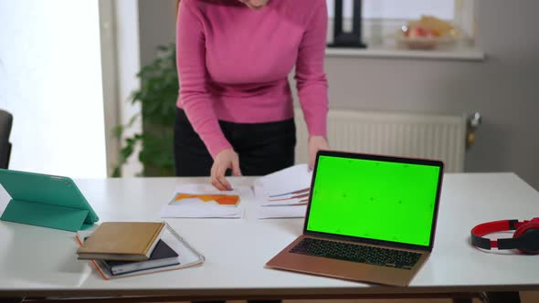 Unrecognizable Troubled Woman Walking Side to Side in Home Office with Green Screen Laptop on Table