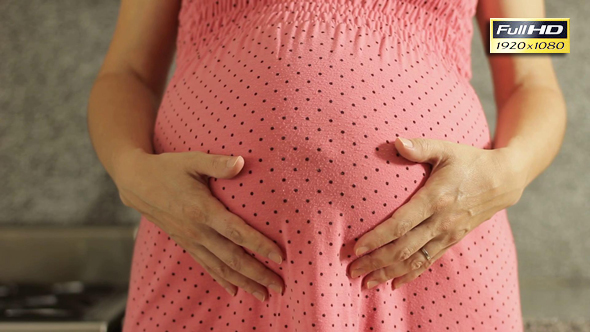 Pregnant Woman with Hands over her Tummy.