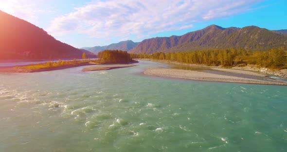 UHD Aerial View. Low Flight Over Fresh Cold Mountain River at Sunny Summer Morning. Green Trees and