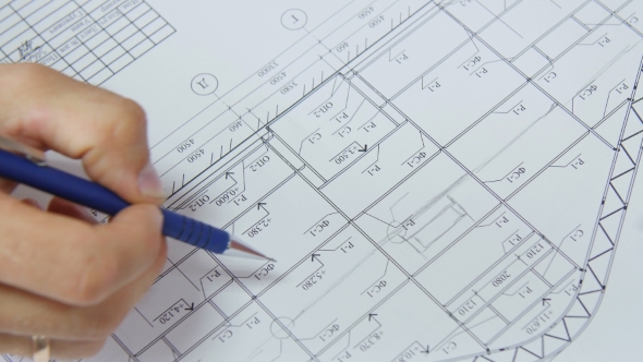 Architect Hand With Pencil Drawing Blueprints