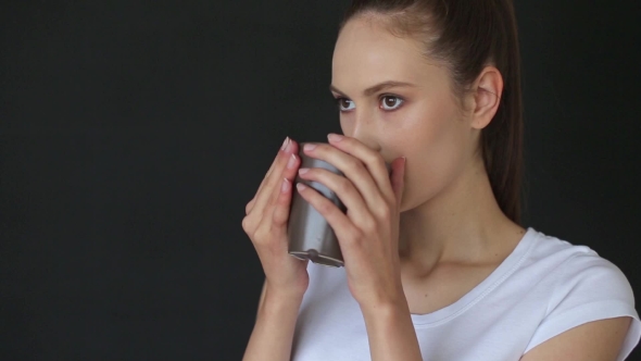 Young Girl Drinking a Delicious Coffee In The Office