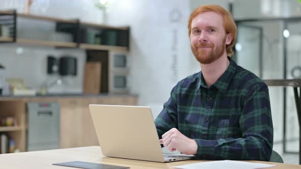 Beard Redhead Man with Laptop Shaking Head in Approval, Yes 
