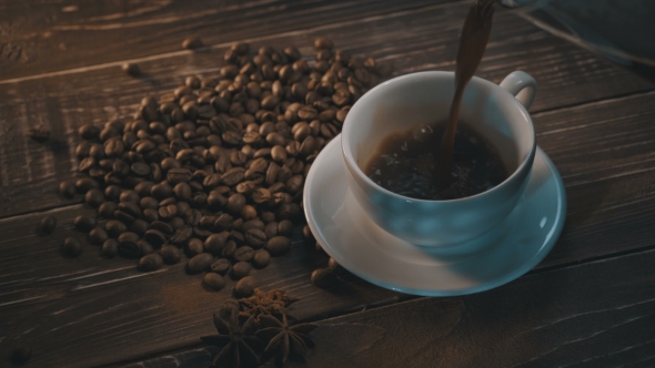 Cup Of Black Coffee With Beans Over Grunge Wooden Table