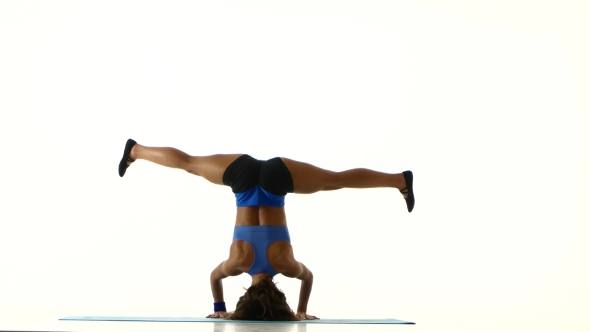 Athlete Stands On His Head And Trains The Body. White