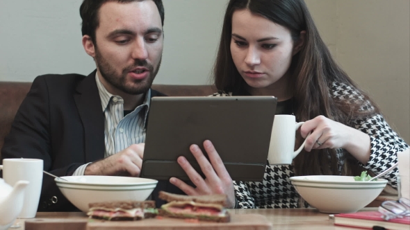 Business Couple At Cafe Use Tablet
