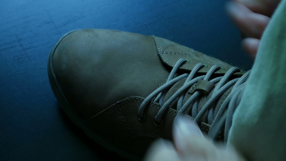 Tying Shoelaces On a Brown Shoe