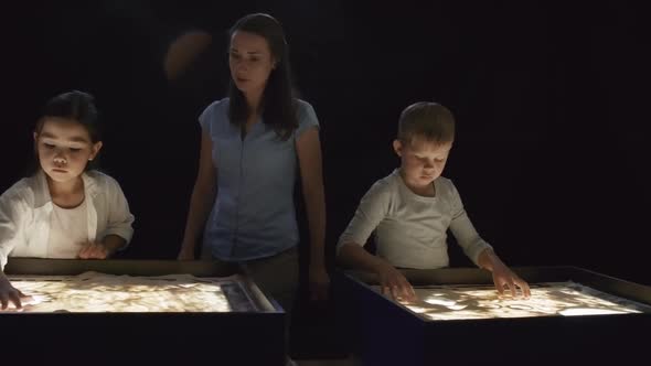 Art Teacher Helping Children Making Sand Animation