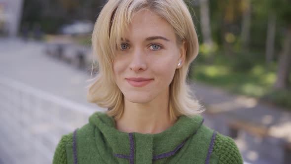 Close-up Face of Young Blond Caucasian Woman with Short Hair Smiling Happily Looking at the Camera