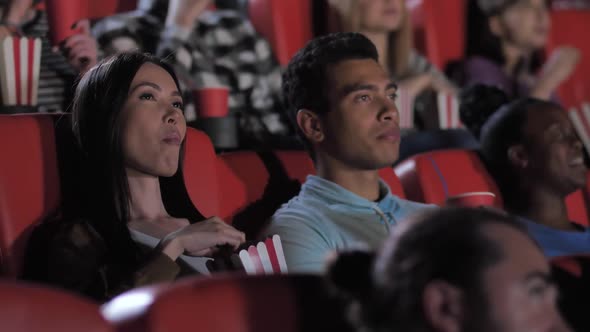 Nice Mixed Race Couple Watching Movie in Cinema