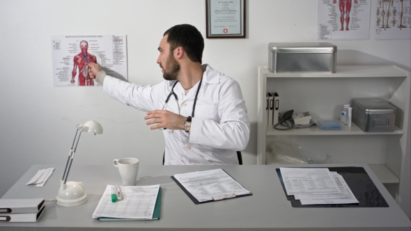 Doctor Explaining About Neck Muscles In Medical Office