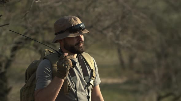 Outdoor Shot of Bearded Man Solder Standing in Field and Guarding Terrirory Wearing Military