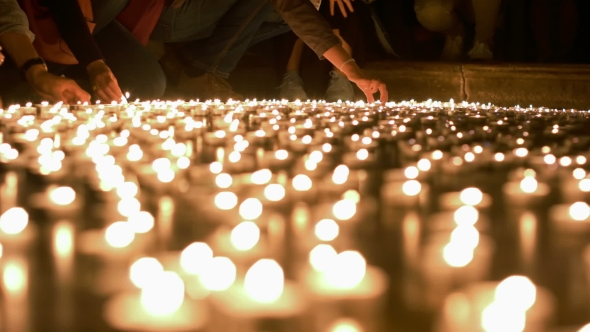 People Firing Up And Placing Candles To Other Ones alt