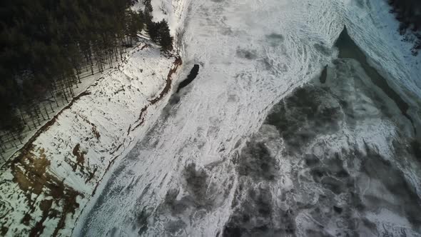 Calm, frozen river covered with ice on cold winter day.