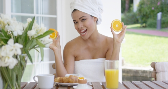 Woman Wrapped In Towel Holding Orange Slices
