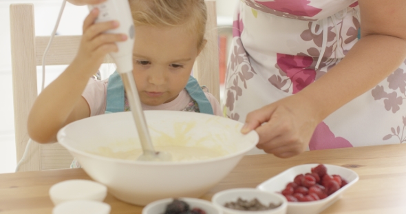 Serious Pretty Little Girl Concentrating On Baking