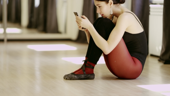 Beautiful Girl Wearing Ballet Leotard With Cellphone