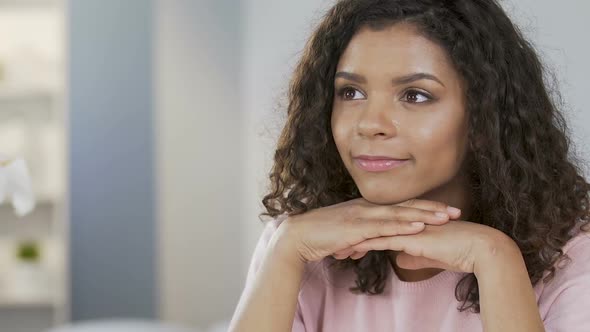 Romantic mixed-race female dreaming about date, remembering her beloved one