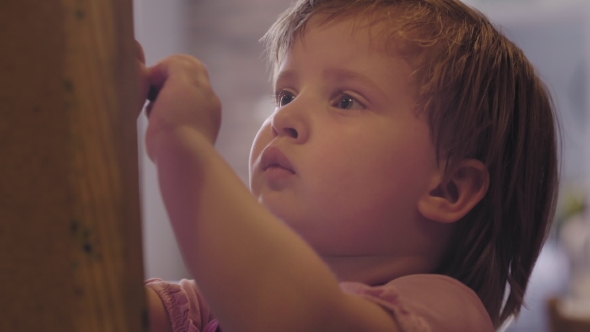 The Little Girl Concentrated On Drawing Canvas.