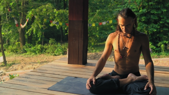 Man In Lotus Position Adjusted For Meditation.