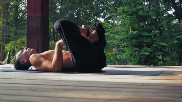 Yogi Lying On The Mat And Perform Exercise Lotus.
