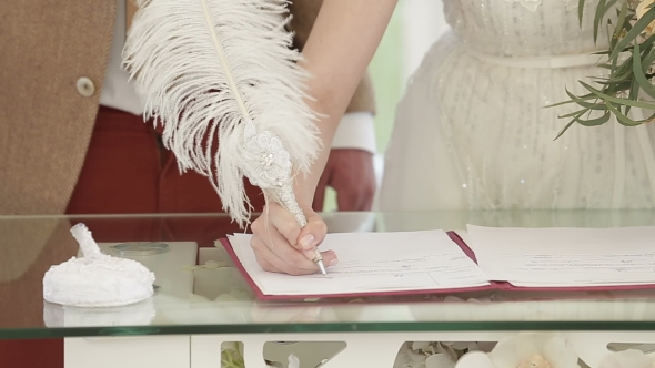 Wedding Ceremony. Wedding Couple Leaving Their Signatures