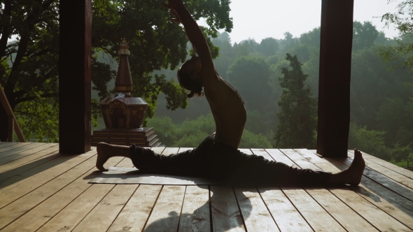 Man Sitting On Splits And Yoga.