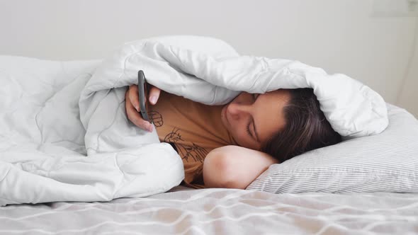 Young Woman Goes to Sleep with Teddy Bear in Her Bedroom