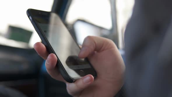 A man reads news from a smartphone.