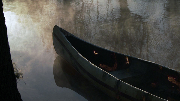 Canoe in Morning Mist in Tigre, Argentina.