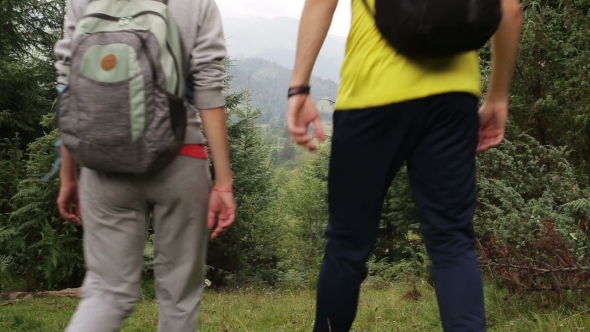 Couple Backpackers Hiking on the Path in Mountains