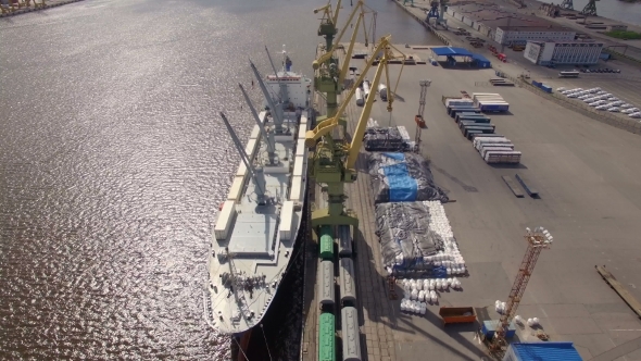 Aerial view of cargo ship in the port awaiting loading