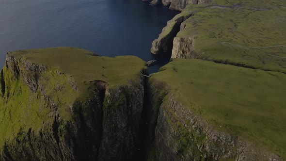 Drone Flight Descending Over Cliff Edges On Coastline