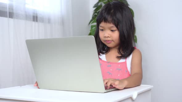 2021 T0 X Me C020Happy a little Asian girl learning online at home. Concept of education online9