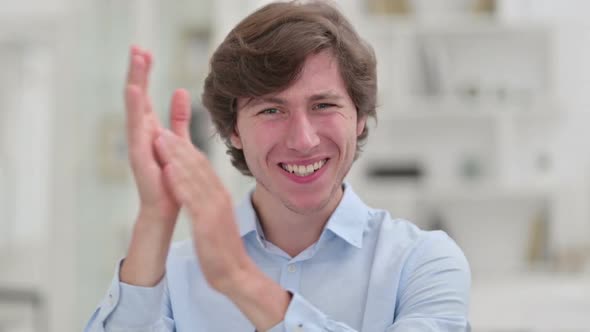 Portrait of Appreciative Young Businessman Clapping