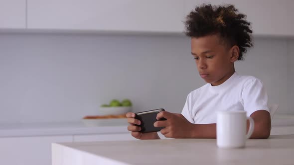 African American Teenager Boy Playing Games on Phone Spbi